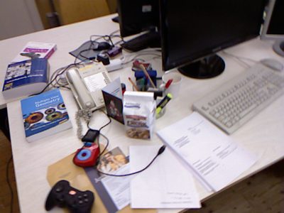The same desk 0.2 seconds later, after the camera moved about 8.5 cm to the left and turned about 9 degrees: the source frame