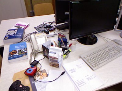 Kinect colour image of a cluttered office desk with a monitor, keyboard, phone, books and papers: the target frame